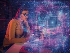 Woman in glasses at a computer with a starry burst image superimposed on top