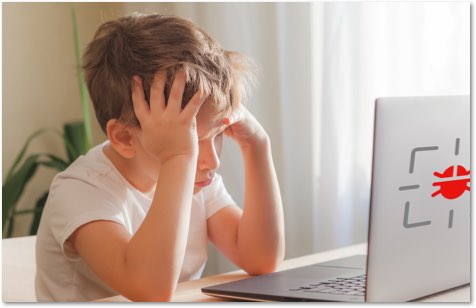 young boy with his head in his hands staring at a laptop with a virus icon on the back