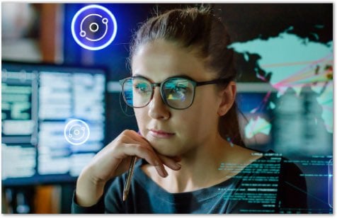 Woman in glasses working on a monitor