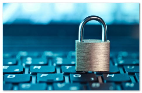 Gold padlock sitting on top of a computer keyboard