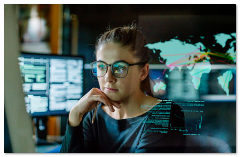 Woman in glasses working on a monitor
