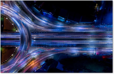 Highways crossing each other with blurred moving traffic from an aerial view