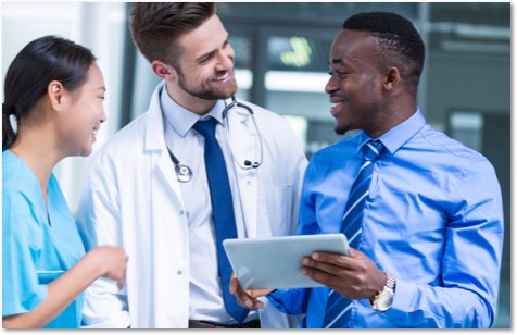 Asian woman in light blue scrubs next to a white male doctor and a black male with a tablet computer