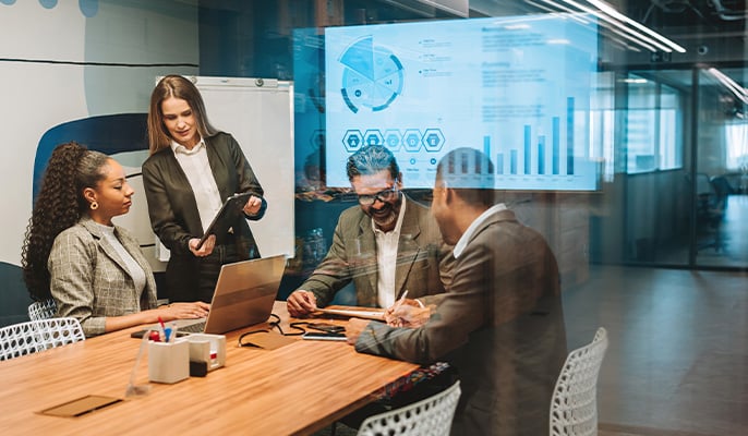 people meeting in a conference room with a glowing screen floating above them
