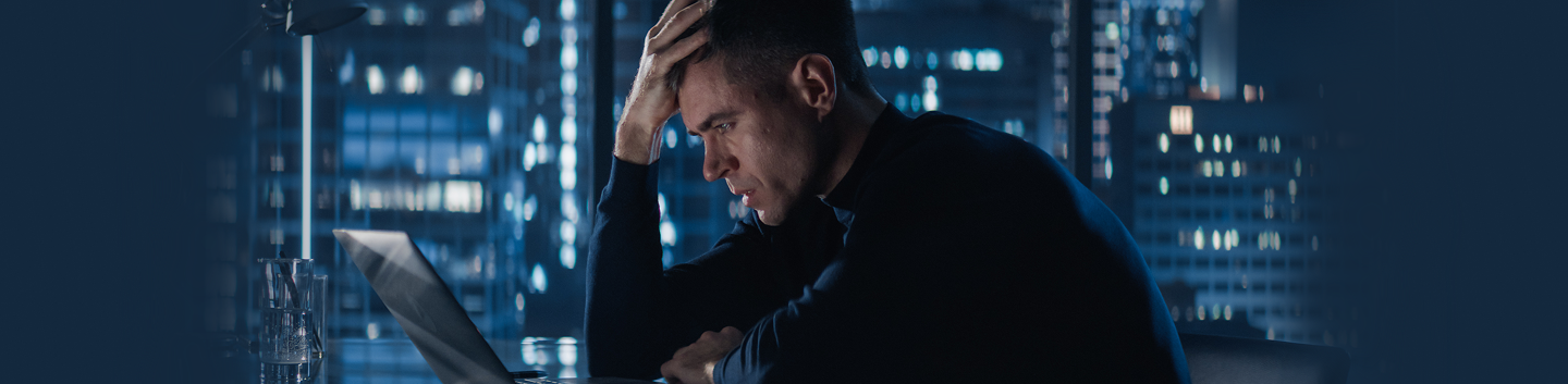 frustrated looking man with his head in his hands