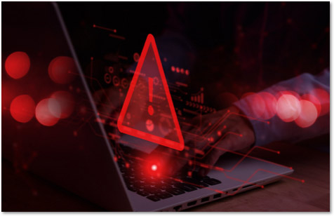 Red exclamation mark in a red triangle floating above a laptop keyboard