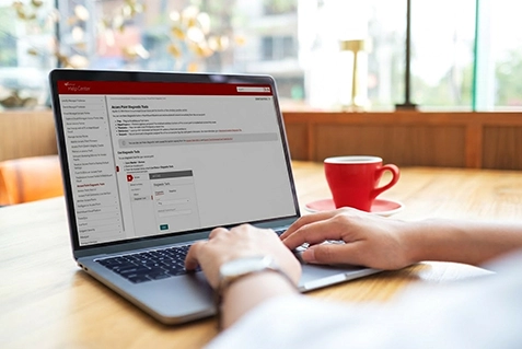 Person looking at WatchGuard help pages on a laptop 