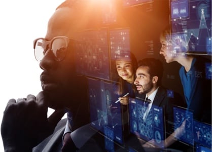 Black man looking thoughtful with 3 SOC technicians superimposed on the right side of the photo