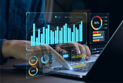 Colorful circle and bar charts floating in front of a laptop screen