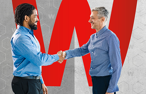 Partners shaking hands in front of a large red W