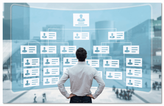 Man standing in front of a wall of user profiles projected on a giant screen