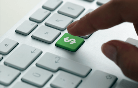 index finger about to press a green keyboard button with a white dollar sign on it 