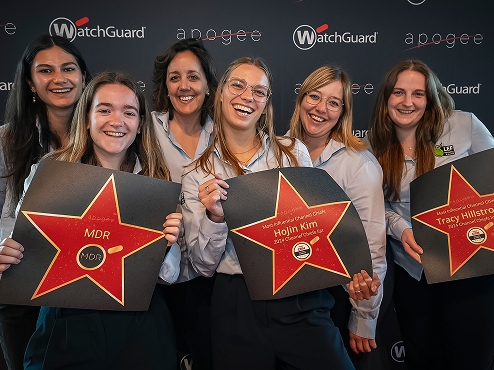 WatchGuard salespeople holding red and gold star awards