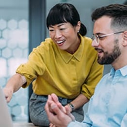 Two people collaborating on a computer