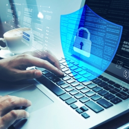Hands typing on a laptop with a digital shield and lock overlay, representing network security.