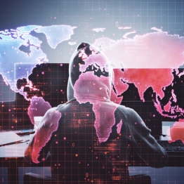 Hooded cyber threat actor in front of a global digital map representing Iran-linked cyber-espionage and geopolitical cyber risk.