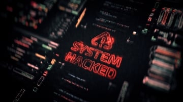Dark cybersecurity interface displaying a glowing red “System Hacked” warning surrounded by blurred code and system data.