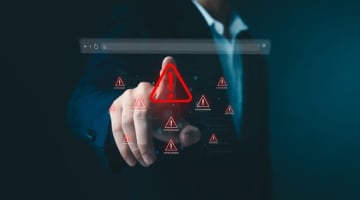 Business professional interacting with a digital browser interface displaying cybersecurity warning alerts, representing malware and compromised website threats.