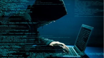 Malware Evasion Techniques Webinar - hacker leaning over a laptop computer in a hoody