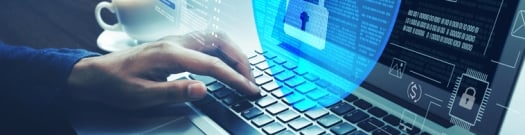 Person typing on a laptop with a transparent digital shield and lock icon overlay, representing cybersecurity, data protection, and secure online access.