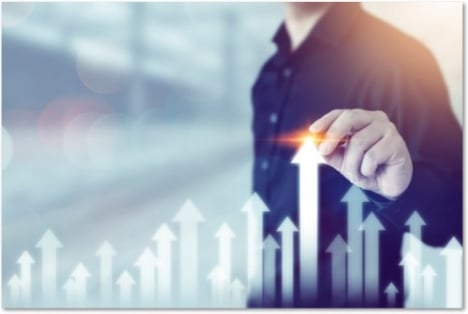 Man in a button down shirt pulling an arrow up out of a row of arrows