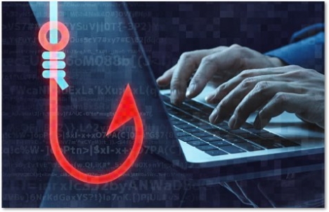 Red fishhook in front of someone typing on a laptop keyboard