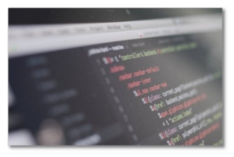 Close up of a screen with color-coded script coding on a black background