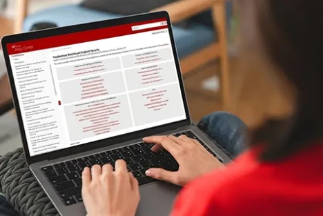 Woman looking at WatchGuard help pages on her laptop
