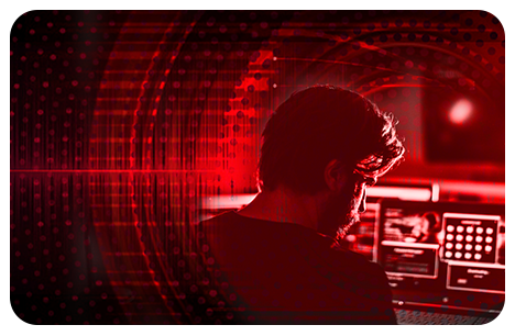 Red Cell blog image of a person at a computer with a red background