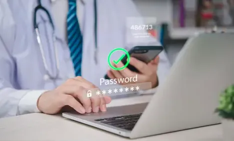 Doctor using a mobile phone and a laptop