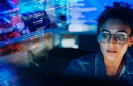woman in glasses with SOC screens around her