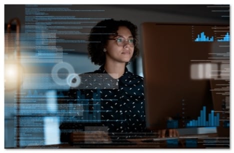 Woman in glasses with rushing code lines superimposed in front of her