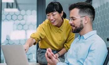 Two people collaborating on a computer