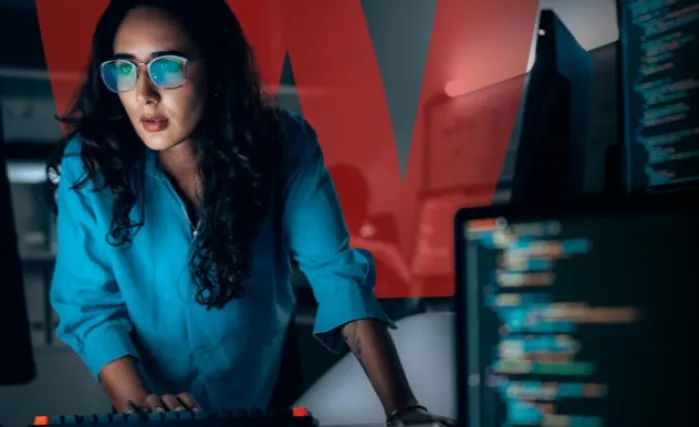 Woman in a blue top working in a SOC