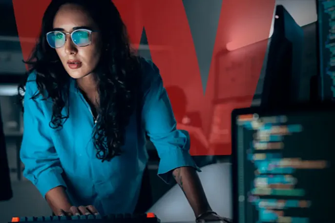 Woman in a blue top working in a SOC