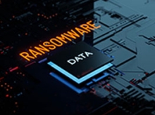 Circuit board with ransomware written in orange above a raised button that reads data