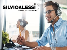 Man and a woman working in a sunny office with headsets on