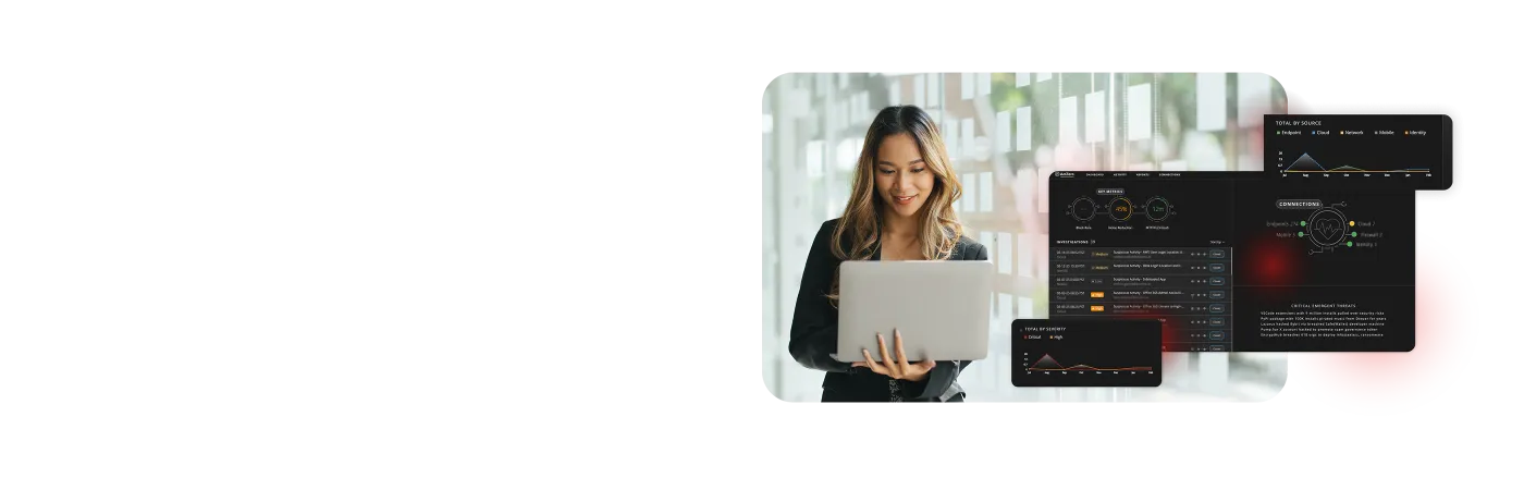Woman looking at a laptop with WatchGuard MDR dashboards next to her