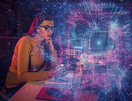Woman in glasses at a computer with a starry burst image superimposed on top