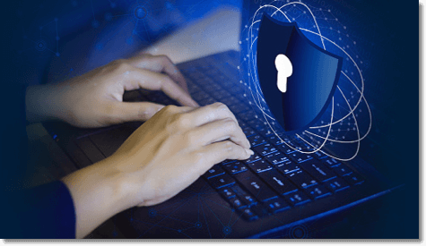 hands typing on a laptop keyboard with a blue shield icon in front
